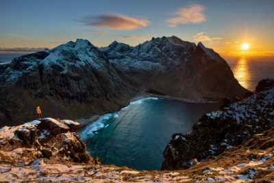 Personnage face au sunset au sommet du Ryten dans les îles Lofoten en Norvège.